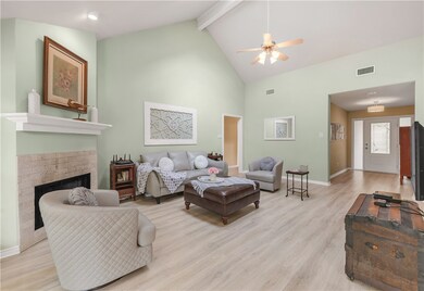 Living room featuring high vaulted ceiling, beamed