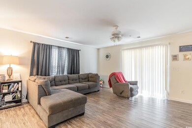 Living room featuring hardwood / wood-style floors and ceiling fan