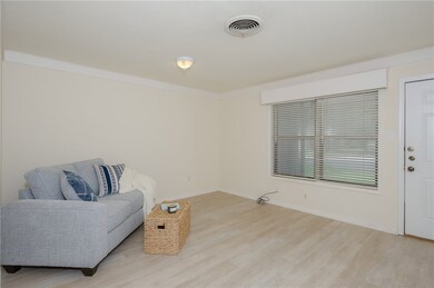 Sitting room featuring wood-type flooring and crow