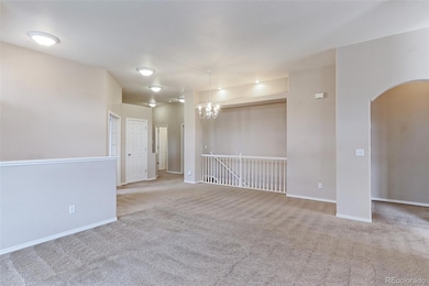Another great view of the living room. Just past the closet door there are 4 steps down to the landing and another 3 steps to the garage floor.  Behind the white railing is the basement staircase.