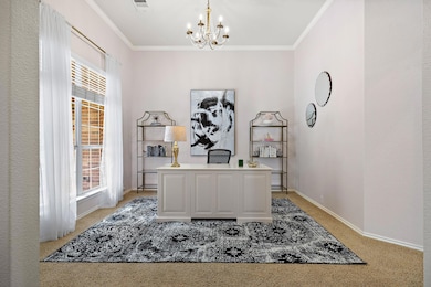 Office area with light carpet, a chandelier, plen