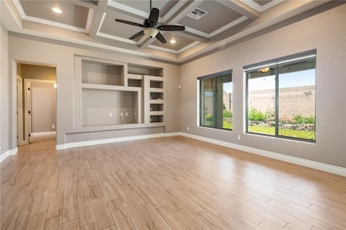 Spare room with a ceiling fan, coffered ceiling, l