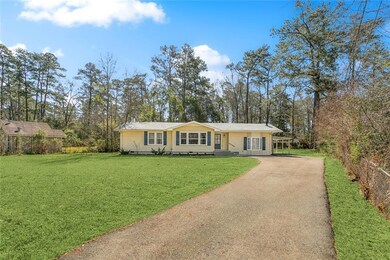Long driveway leading to home and carport and expa
