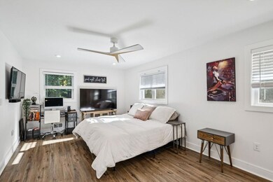 Primary Suite with an Ensuite Bath featuring a Walk-In Shower with Chevron Tile