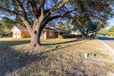 Ranch-style house with brick siding