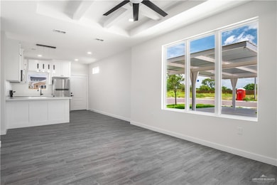 Unfurnished living room with a ceiling fan, recessed lighting, and wood finished floors