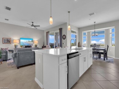 Kitchen with stainless steel dishwasher, healthy amount of natural light, ceiling fan, and light tile patterned flooring