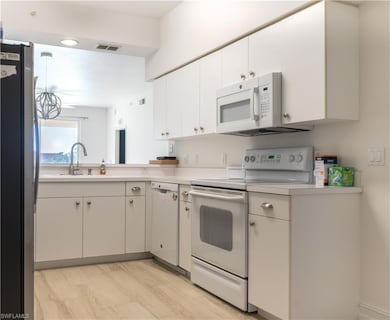 Kitchen featuring light countertops, visible vents