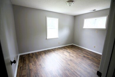 Empty room featuring dark hardwood / wood-style fl