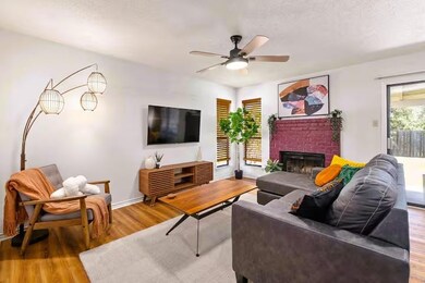 Living room featuring wood finished floors, a cei
