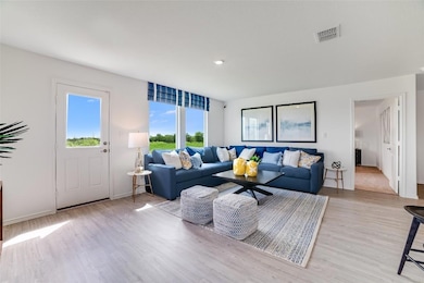 Living area with light wood finished floors and b