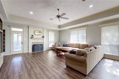 Living room featuring a tray ceiling, plenty of na