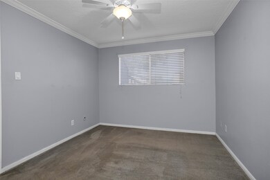 One bedroom with ceiling fan, crown moulding, and