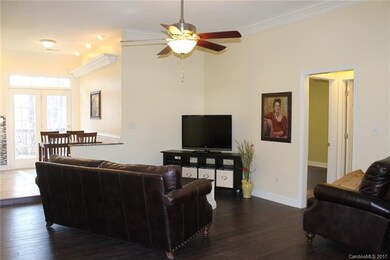 Living room has hardwood floors, crown molding and