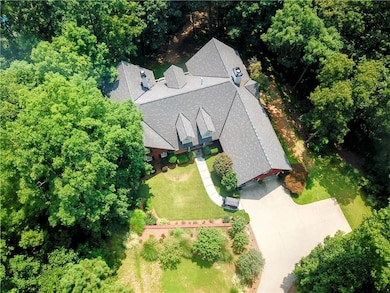 Bird's eye view of the home showing complete privacy, oversized garage and large backout area in driveway.