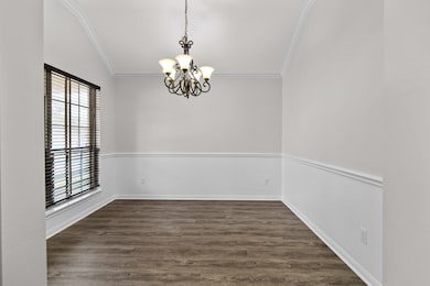 The formal dining room is to your left at your enter the home, featuring tastefully placed chair rails, crown molding, vaulted ceilings, and beautiful two inch wood blinds. This room could easily be converted into your home office, as the open breakfast area is large enough for a large dining table.