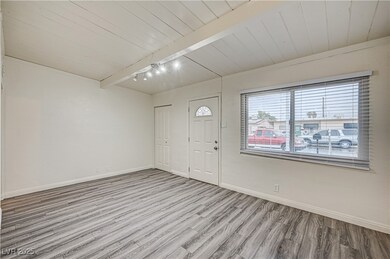 Foyer featuring baseboards, beamed ceiling, wood c