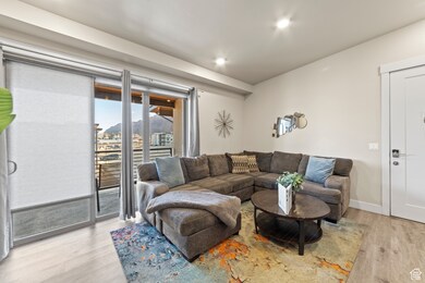 Living room with light wood-style flooring, recessed lighting, and a mountain view