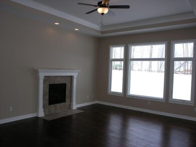 Great room with step ceiling trimmed with crown mo