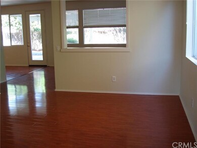 ANOTHER VIEW OF THE LIVING ROOM WITH RICH MAHOGANY