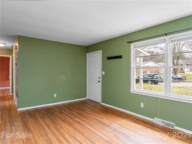 Spacious living room with original hardwood floors.
