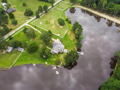 Birds eye view of property with a water view