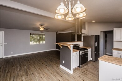 Kitchen with stainless steel gas range, refrigerat