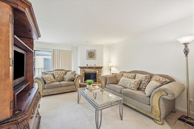 Spacious living room with fireplace and balcony.
