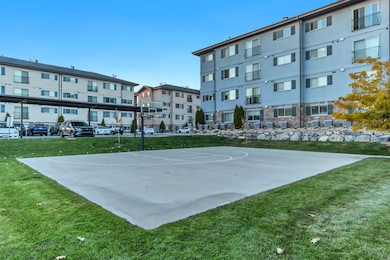 View of basketball court featuring a yard and community basketball court