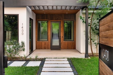 Doorway to property featuring stucco siding