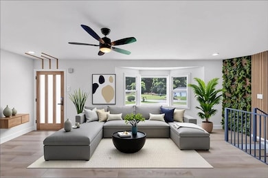 Living area with ceiling fan, wood finished floors, and recessed lighting