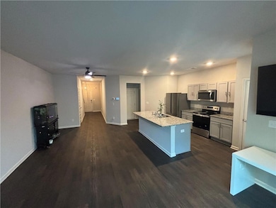 Kitchen featuring stainless steel appliances, dark