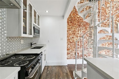 Renovated kitchen with granite countertops, stainless appliances, and open layout for modern living.