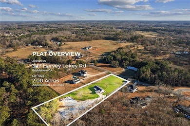 Aerial view of property's location featuring property parcel outlined and a heavily wooded area