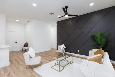 Living room featuring light wood-style floors, bas