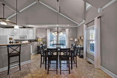 Tiled dining area featuring beamed ceiling, ceilin