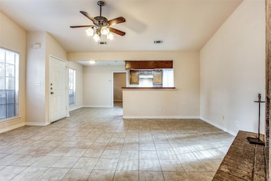 Unfurnished living room with ceiling fan, light t