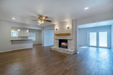 Large family room with whitewashed fireplace brick