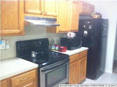 One view of kitchen with beautiful cabinets.
