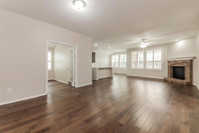 Unfurnished living room with ceiling fan, a firepl