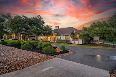 View of front of house featuring curved driveway,