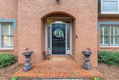 Property entrance featuring brick siding