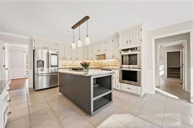 Kitchen featuring light stone counters, stainless 