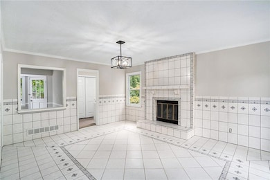 Unfurnished living room featuring a wealth of natural light and tile walls