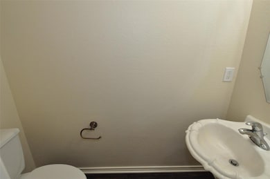 Half bath featuring toilet and a sink