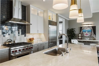 Kitchen featuring wall chimney exhaust hood, high 