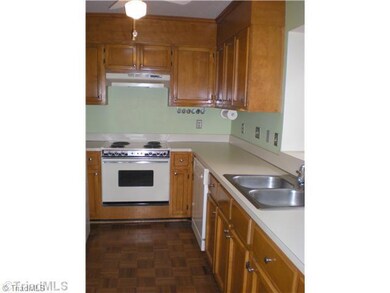 Kitchen. Charming galley kitchen has lots of cabinets and plenty of counter space.