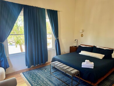 Bedroom featuring wood finished floors and baseboards
