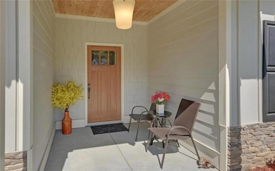 View of exterior entry featuring stone siding