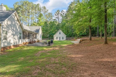 View of green lawn with a patio area